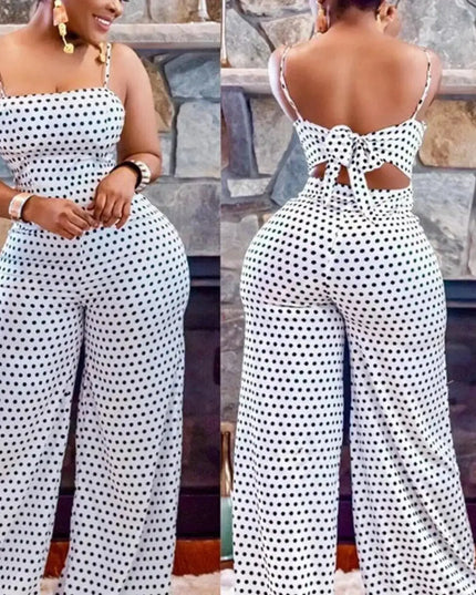 Woman wearing a black and white polka dot jumpsuit with cut-out design, shown from front and back.