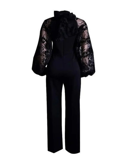 Black jumpsuit with sheer lace sleeves on a white background