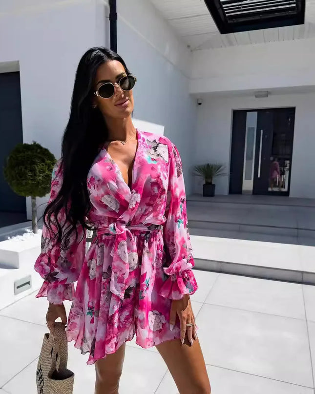 Woman in a pink floral dress standing in a modern indoor setting