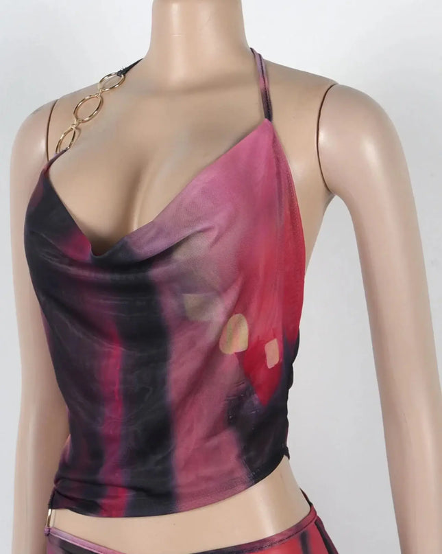 Mannequin wearing a red and black tie-dye top with gold accents on a white background