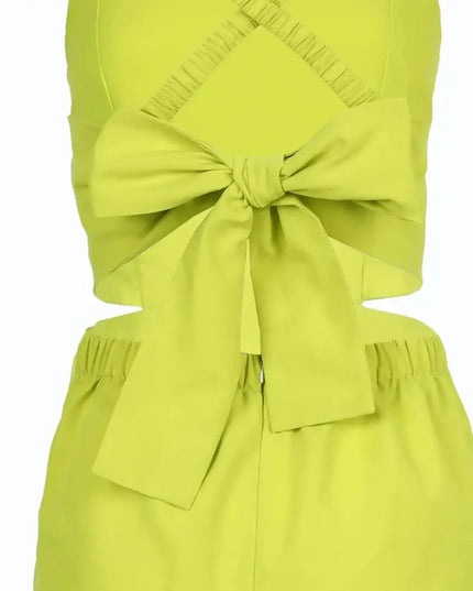 Green dress with a large bow detail on a white background