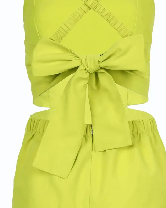 Green dress with a large bow detail on a white background