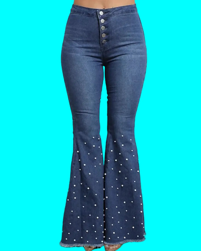 Blue flared jeans with white button details on a neutral background