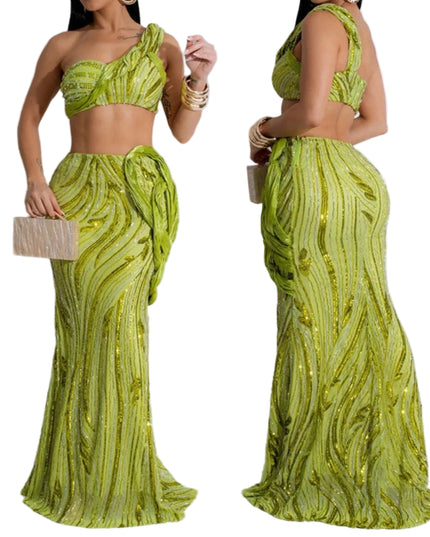 Woman wearing a green sequined dress with a matching clutch against a white background