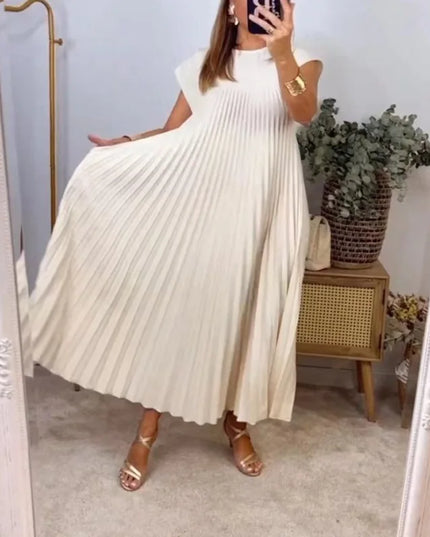 Women’s elegant sleeveless dress with pockets in beige, featuring a pleated design and flowing silhouette.