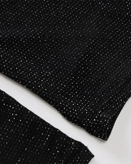 Close-up of black glittery fabric on a white background