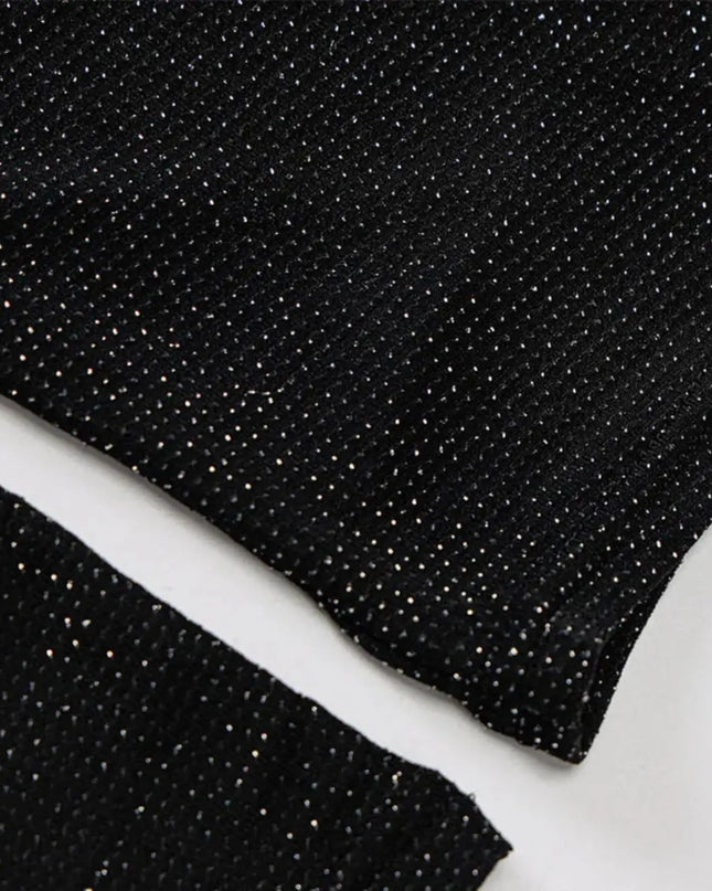 Close-up of black glittery fabric on a white background