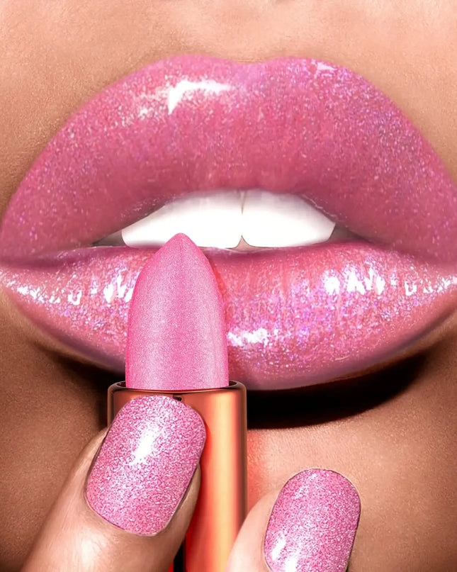 Close-up of a person applying pink glittery lipstick to their lips.