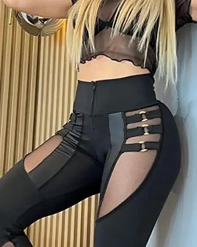 Black leggings with cut-out design worn by a person, against a neutral background.