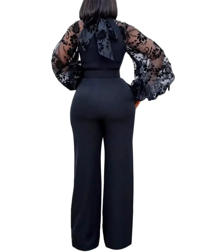 Black jumpsuit with sheer sleeves on a white background
