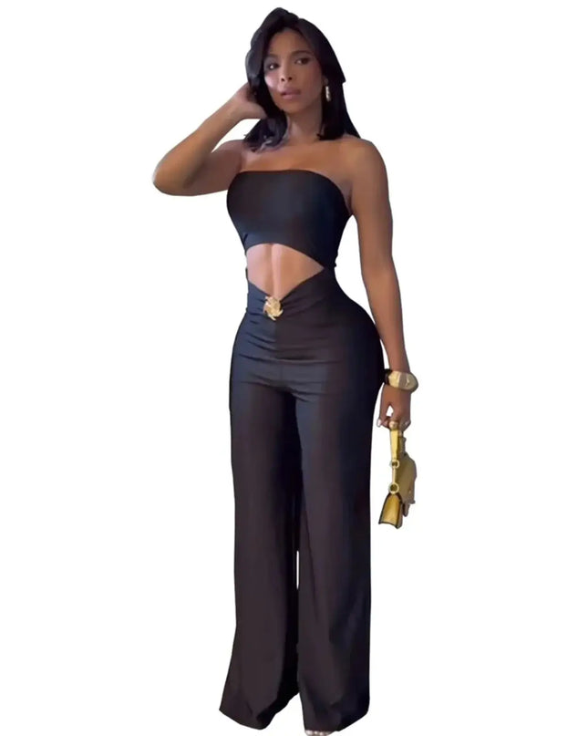 Woman wearing a black strapless top and wide-leg pants on a white background