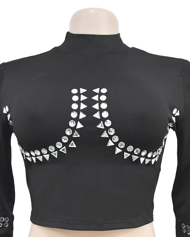 Black long-sleeve top with decorative silver embellishments on a mannequin against a white background