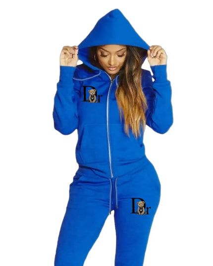 Person wearing a blue tracksuit with a logo on a gray background