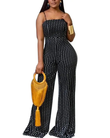 Woman wearing a black polka dot jumpsuit holding a yellow handbag on a white background