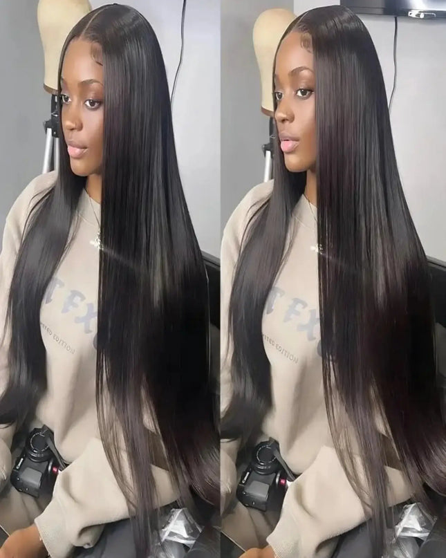 Person with long black hair styled in a sleek manner, wearing a beige sweatshirt.