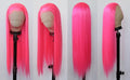 Neon pink wig on a mannequin head with a plain background