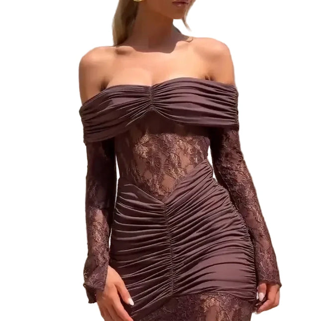 Woman wearing a brown off-shoulder dress with lace details against a neutral wall.