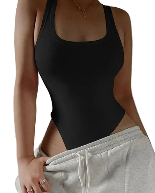 Person wearing a black bodysuit and gray sweatpants against a neutral background