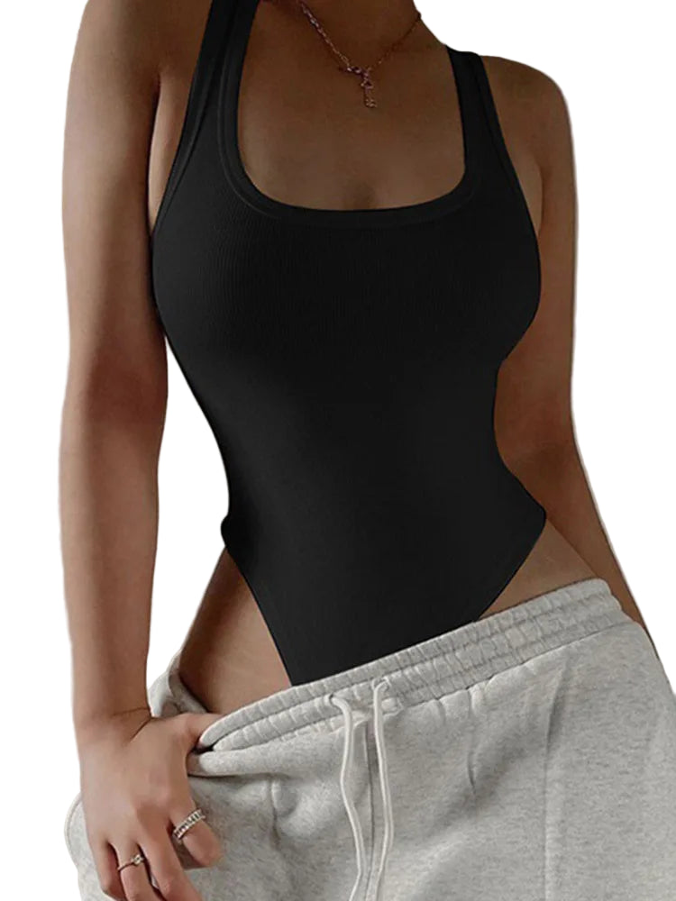 Person wearing a black bodysuit and gray sweatpants against a neutral background