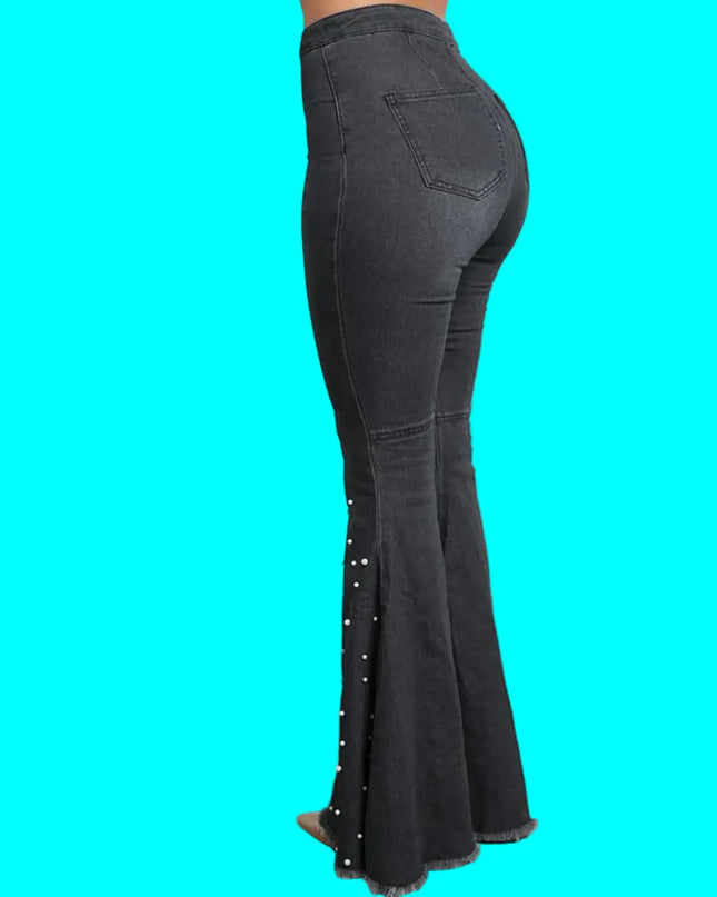 Black flared jeans with decorative elements on a turquoise background