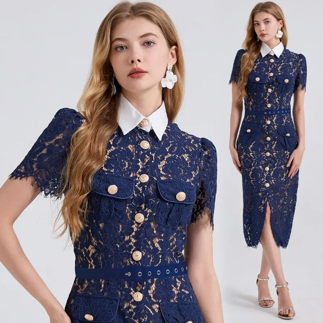 Woman wearing a navy lace dress with a white collar on a light gray background