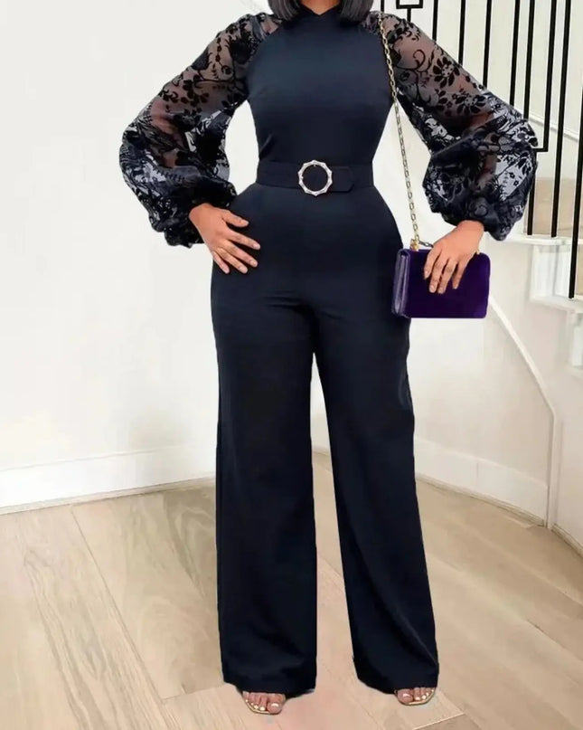 Person wearing a black outfit with sheer sleeves, holding a purple clutch, standing on a staircase.