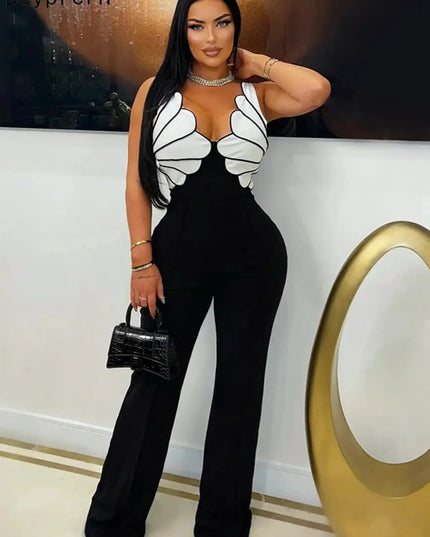 Woman wearing a black and white outfit with butterfly wings, holding a black handbag.