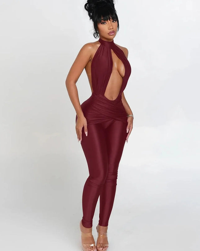 Woman wearing a burgundy jumpsuit with cut-out design on a white background