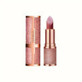 Rose gold lipstick with glittery finish and matching case on a white background