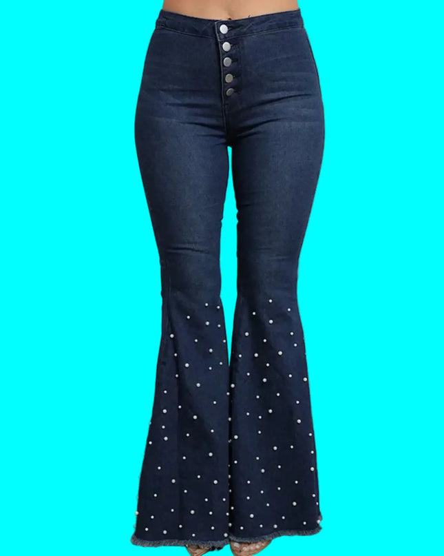 Dark blue bell-bottom jeans with decorative buttons on a turquoise background