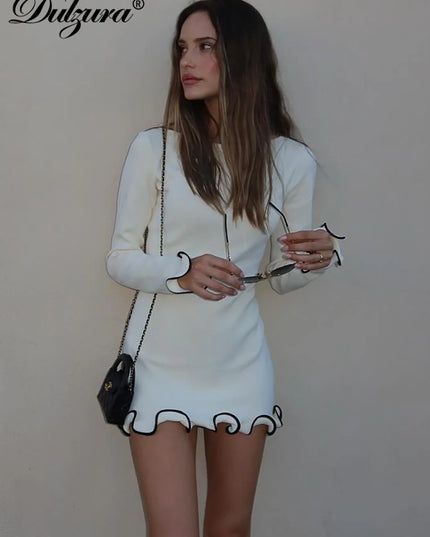 Woman in a white long sleeve ruffled mini dress, showcasing a stylish bodycon fit for modern elegance.