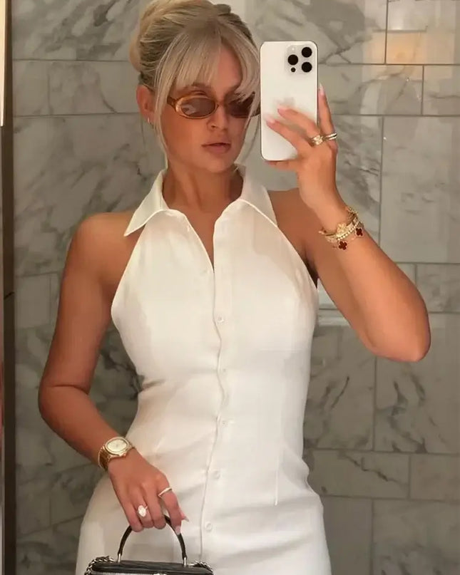 Woman wearing a single breasted white cotton linen summer dress with turn down collar and sunglasses.