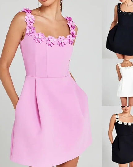 Pink dress with floral details on a gray background