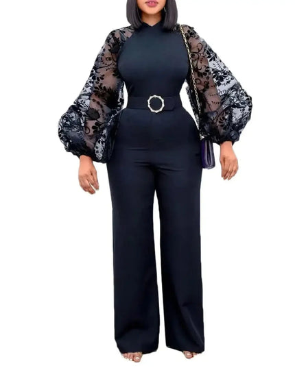 Woman wearing a black outfit with sheer sleeves on a white background