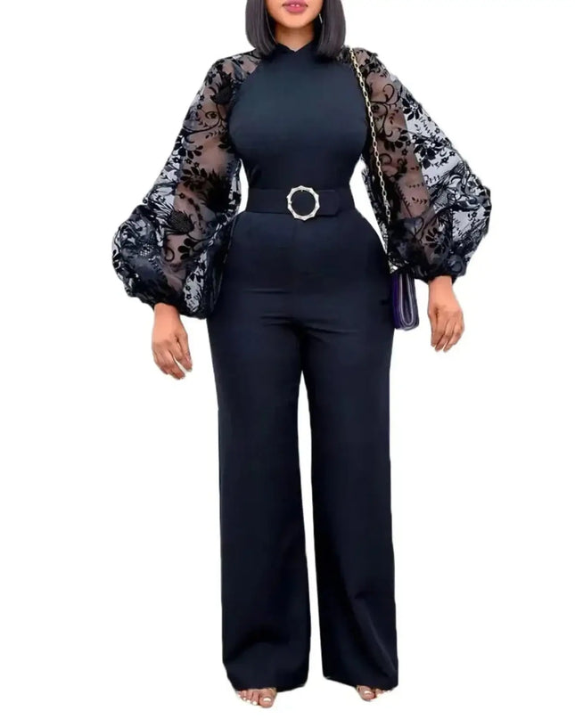 Woman wearing a black outfit with sheer sleeves on a white background