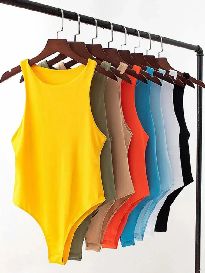 Yellow tank top on a hanger with other colored tank tops on a rack against a white background