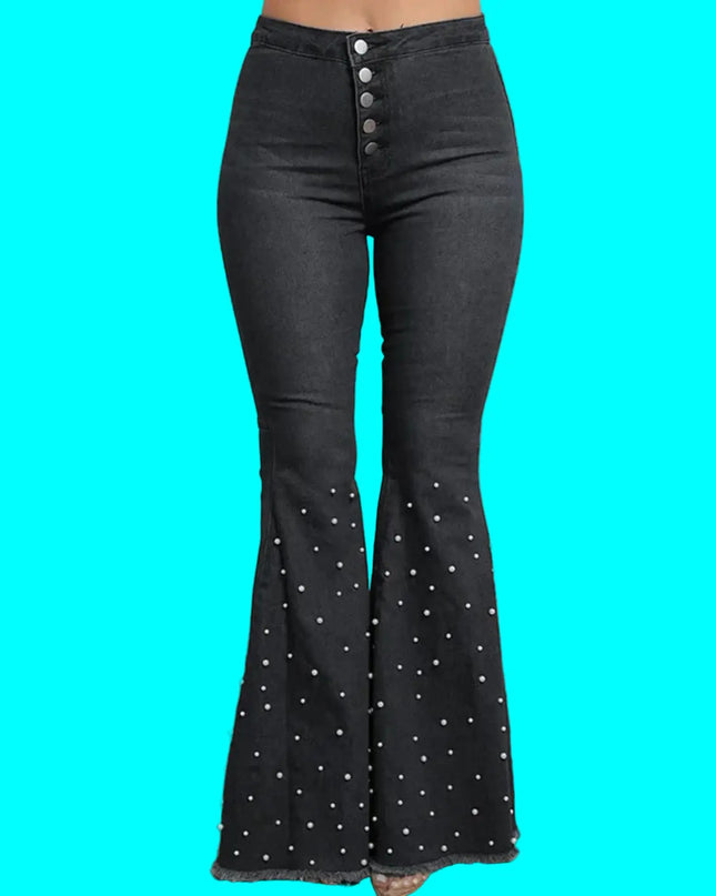 Black flared jeans with pearl buttons on a plain background