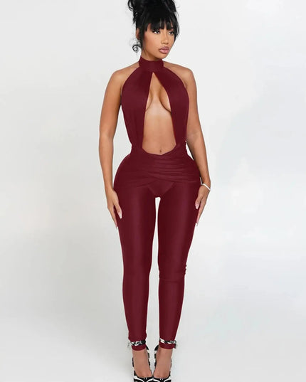 Woman wearing a burgundy jumpsuit with a halter neck design on a white background