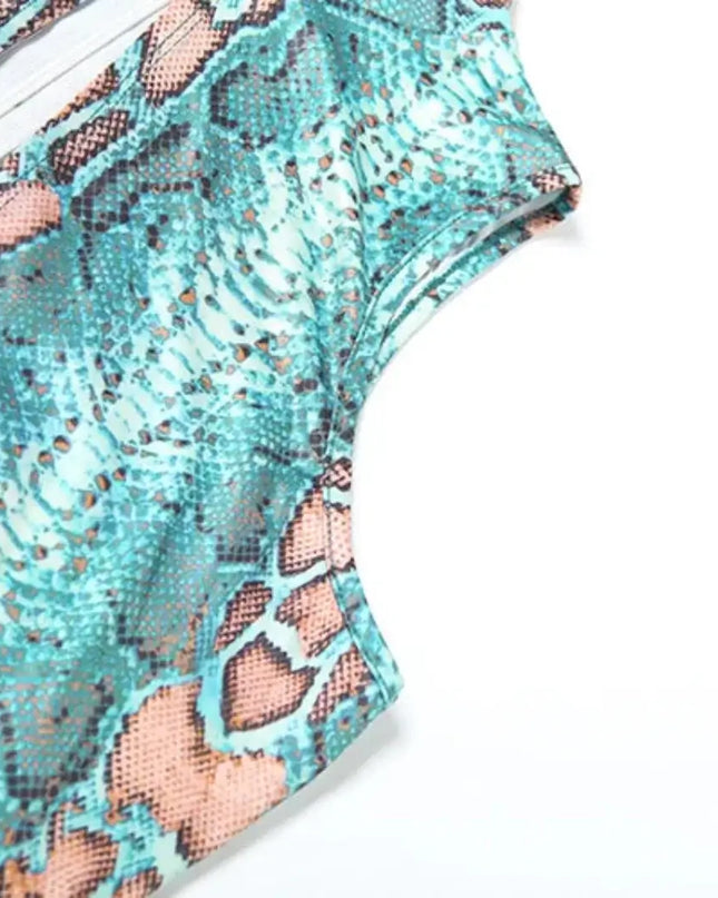 Teal and pink snake print top on a white background