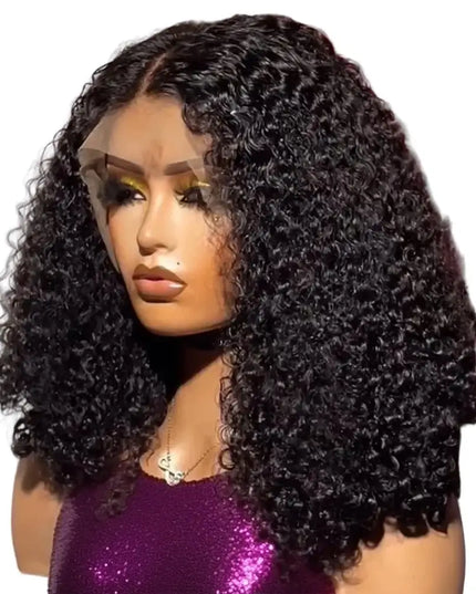 Mannequin head with a black curly wig in front of pink flowers