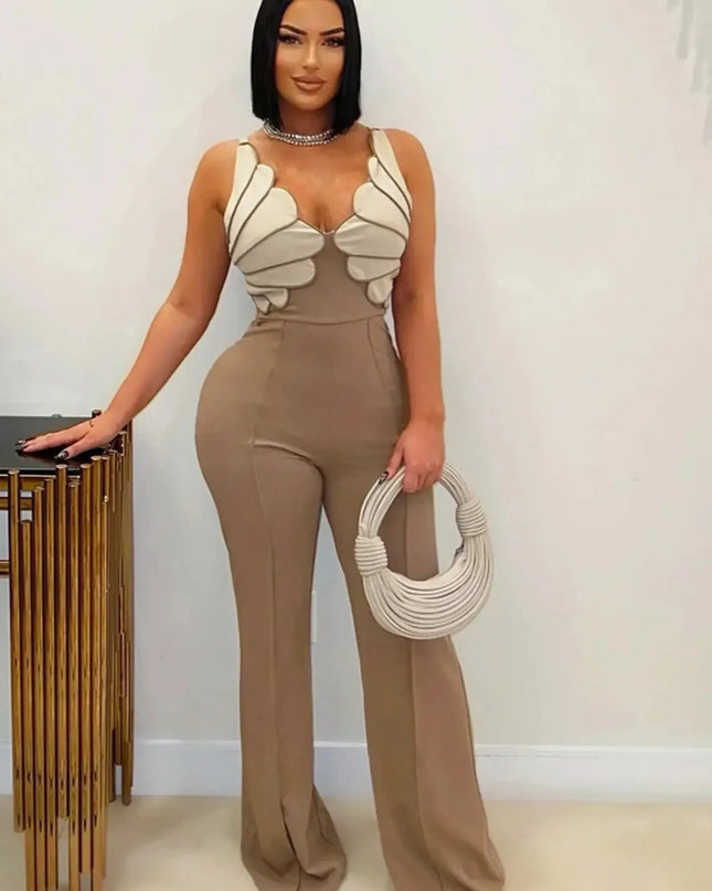 Woman wearing a beige jumpsuit with butterfly-like shoulder designs, holding a matching handbag.