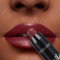 Decolorvers lipstick being applied to a lip with close-up focus.