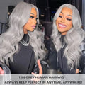 Woman with silver hair looking at herself in a mirror, with text about a 13x6 grey human hair wig.