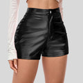 Black leather shorts worn by a person on a plain background