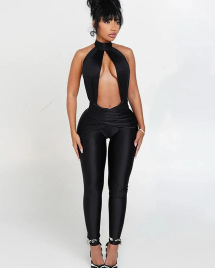 Woman wearing a black jumpsuit on a white background