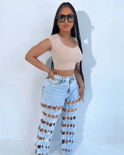 High waist hollow out denim pants styled with a fitted crop top and sunglasses for a chic Y2K streetwear look.
