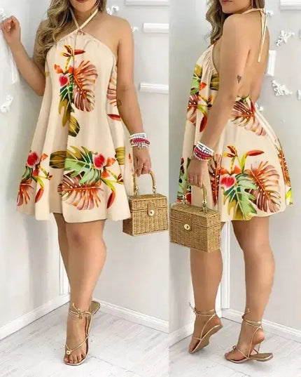 Tropical print halter neck dress in vibrant botanical design, perfect for vacation style, featuring backless silhouette.