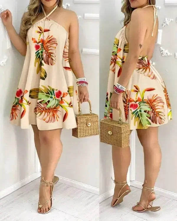 Tropical print halter neck dress in vibrant botanical design, perfect for vacation style, featuring backless silhouette.