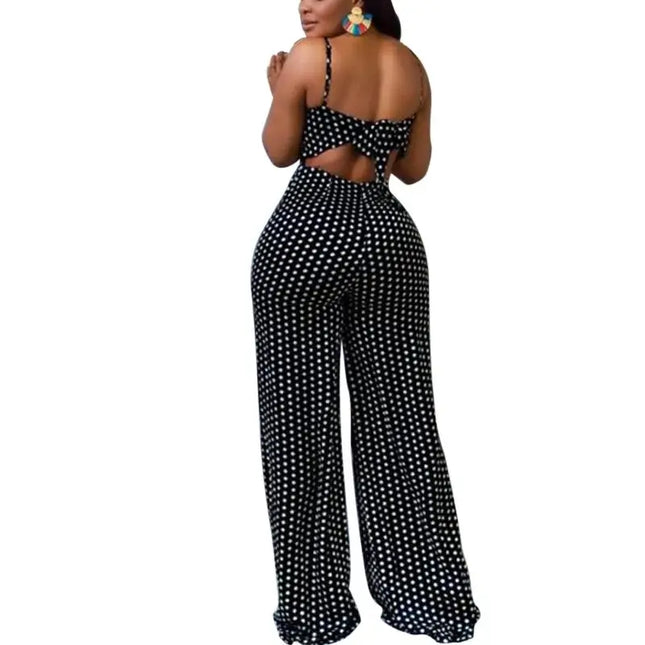 Black and white polka dot jumpsuit with cut-out design on a white background