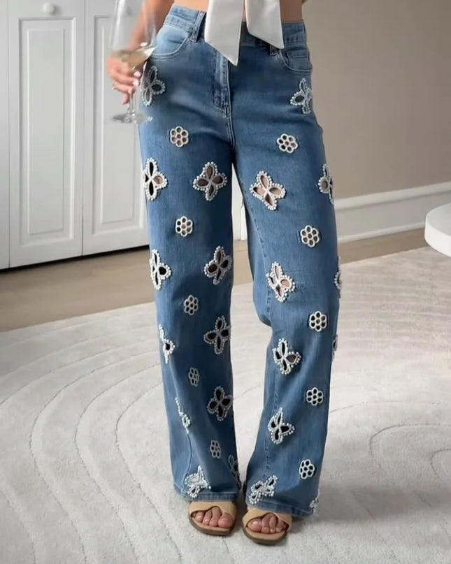 Casual hollow out women’s jeans with floral designs and a loose straight fit, perfect for a trendy urban look.